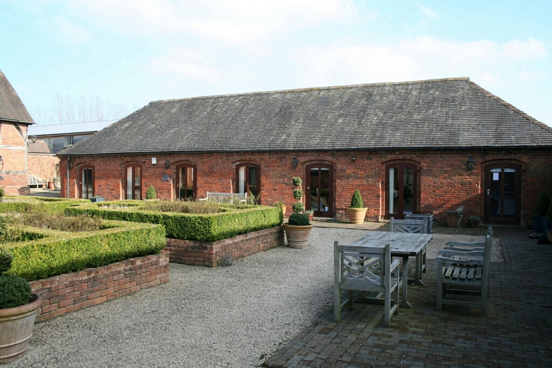 The front of The Long Barn, with seating in the courtyard