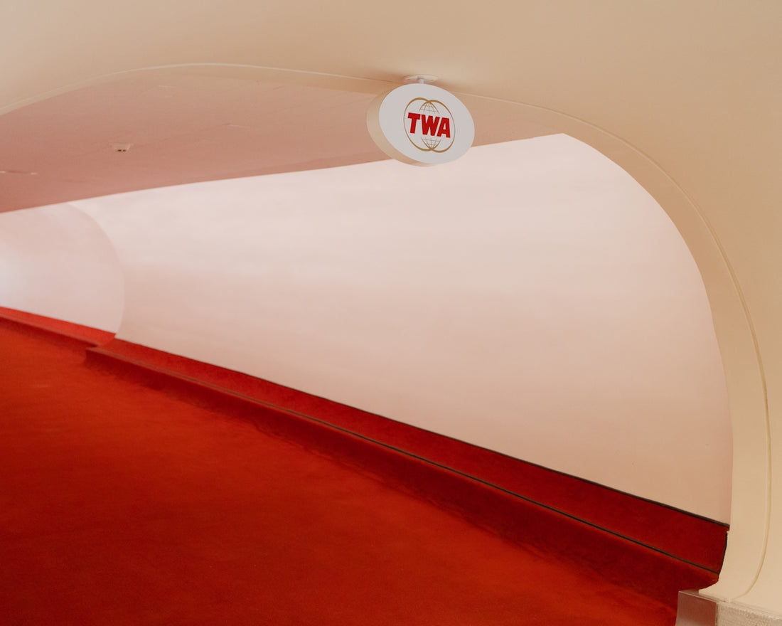 a red and white hallway with a sign on the wall