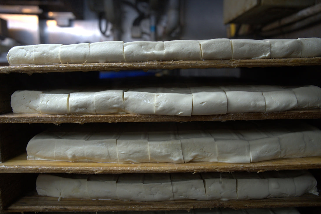 a bunch of bread that are on a shelf