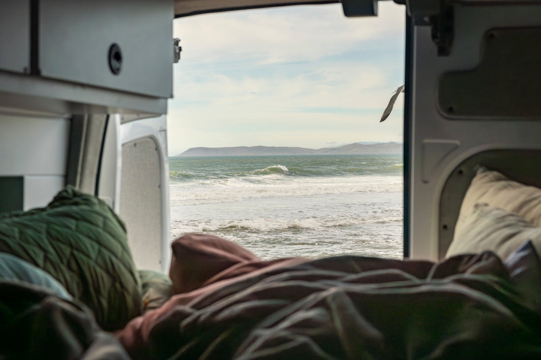 A view of the ocean from inside a camper van