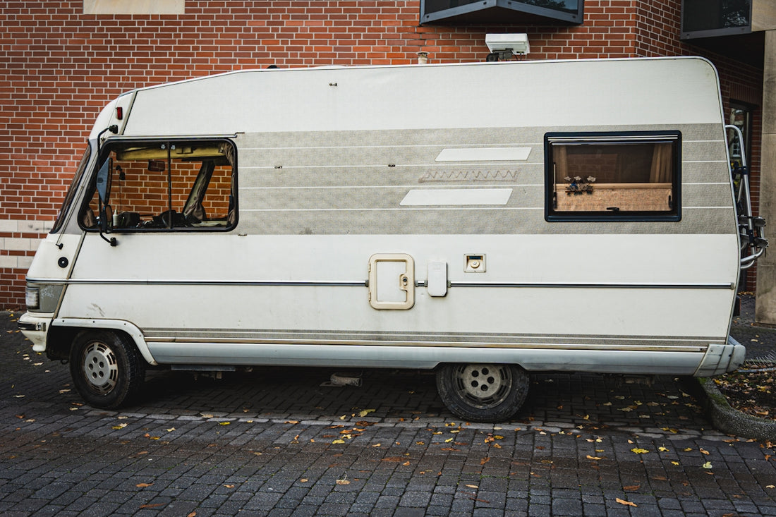 White vintage camper van parked outdoors