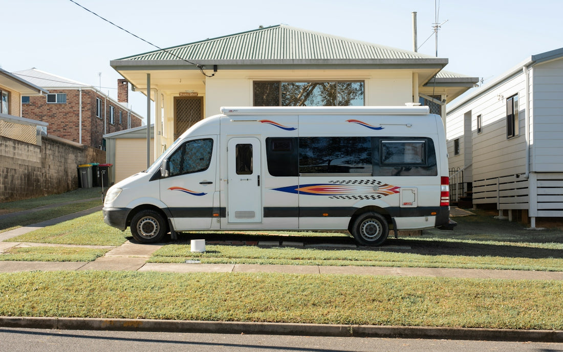 White camper van parked on lawn in front of house