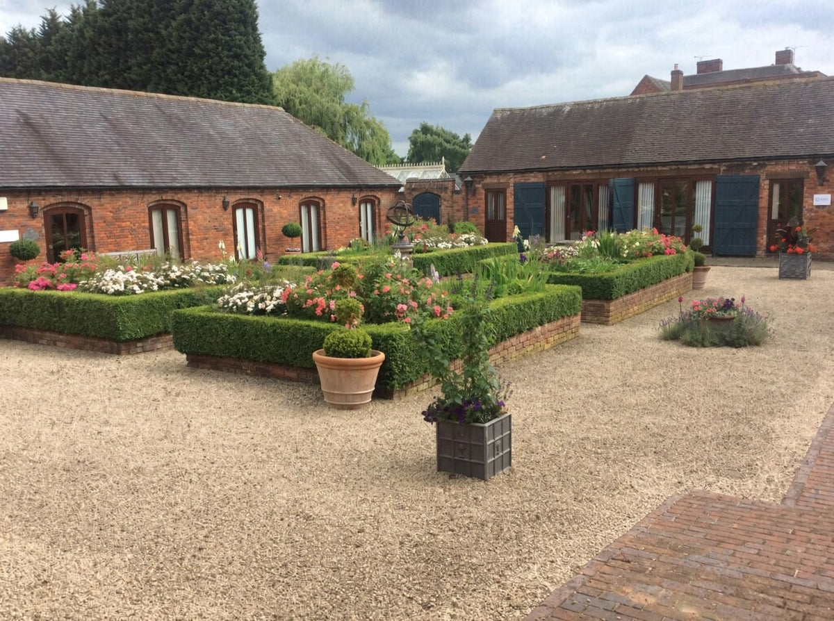 The Long Barn showroom at Hurley, seen across its courtyard garden
